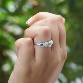 [in finger front view of moissanite round and marquise cut stones]-[Golden Bird  Jewels]