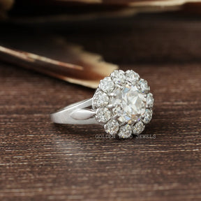 Side View of Round Cut Moissanite Engagement Ring In two fingers