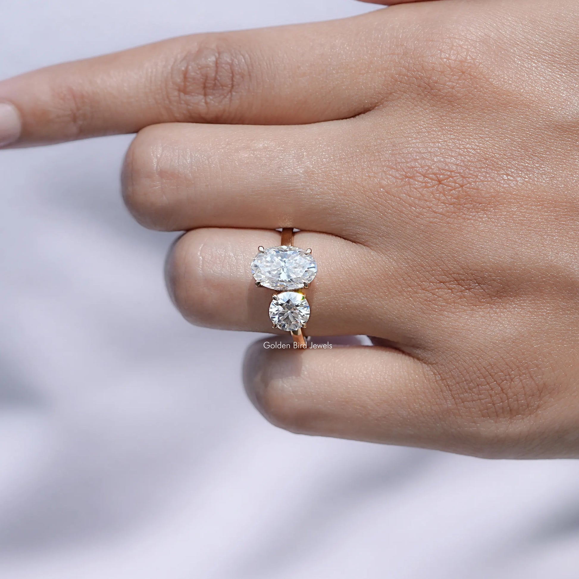 Top View Of Oval And Round Cut Moissanite Toi Et Moi Ring in prongs setting 
