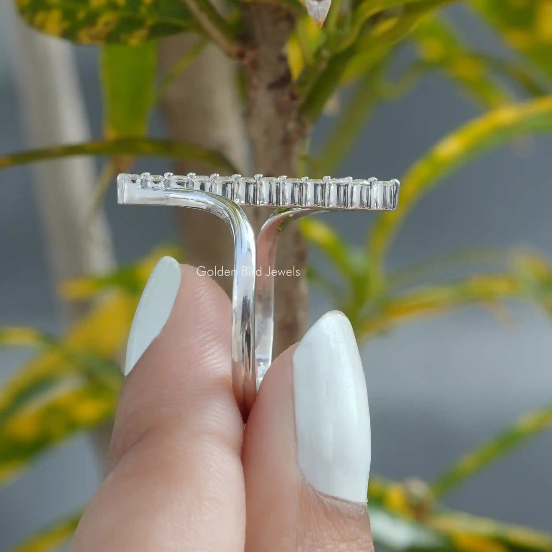 [Round cut moissanite ring set in vertical bar setting & crafted with 18k white gold]