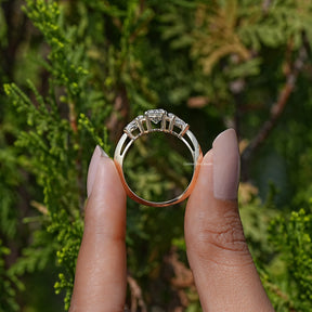 Back View of Round Cut Side Diamond Three Stone Ring In two fingers