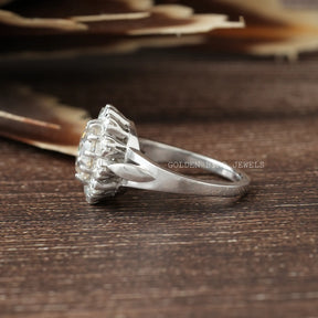 Side View of Round Cut Moissanite Engagement Ring In two fingers