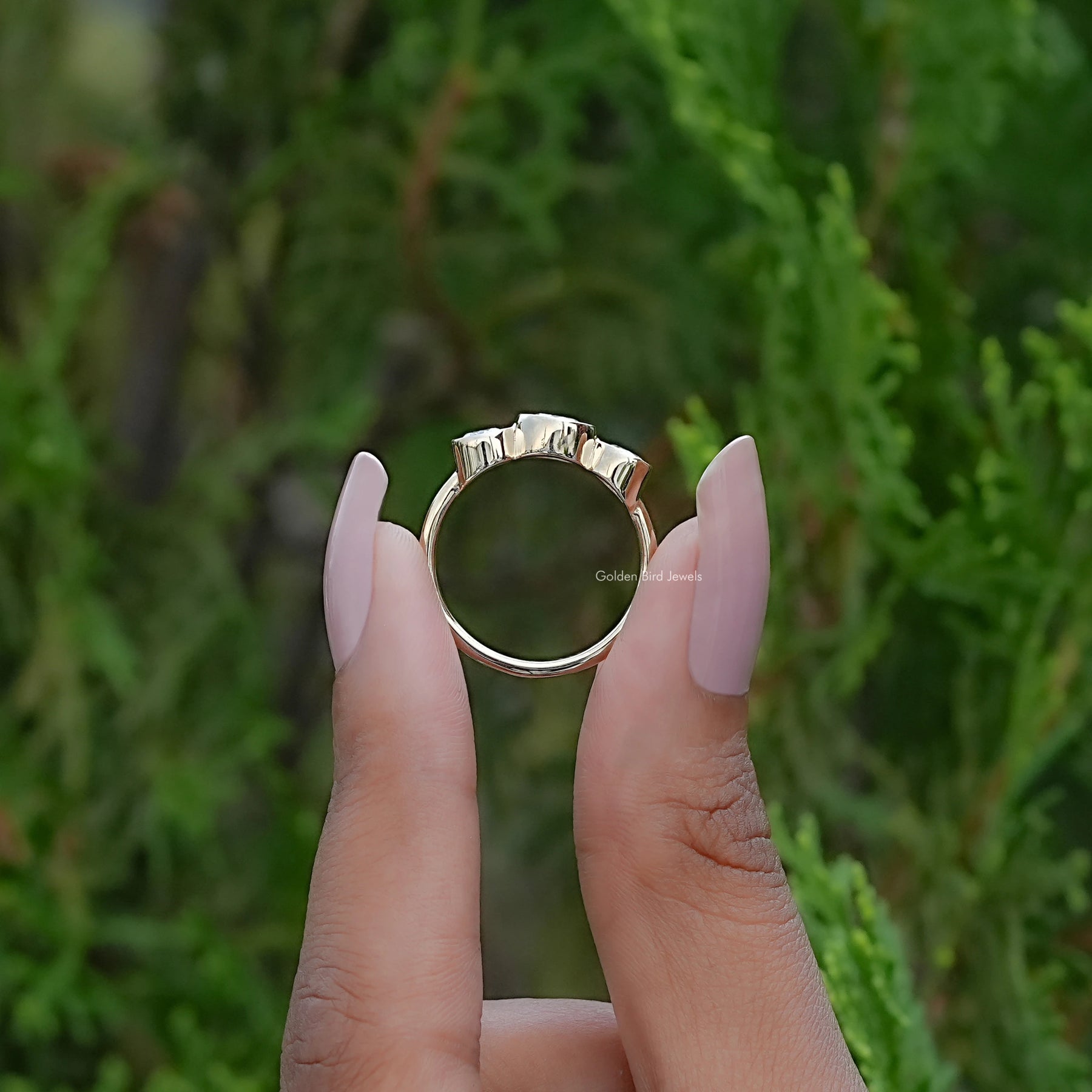 Back view of Round Moissanite Three Stone Bezel Set Ring in secure setting 