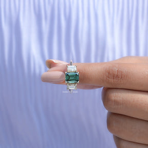 In front finger View Of Emerald Cut 3 Stone Ring