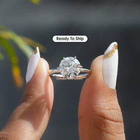 [In two finger front view of round  cut solitaire moissanite ring]-[Golden Bird Jewels]