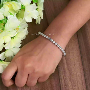 In hand view of round cut moissanite halo bracelet