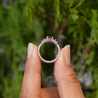 Five-stone ring view of prong-set ruby red hexagon-cut center and side gemstones