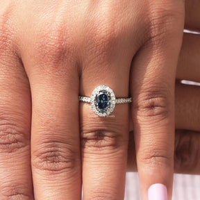 Close-Up View of Sapphire Blue Oval Cut Halo Bridal Ring In White Gold