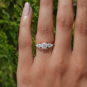 View of Pear And Round Cut Diamond Three Stone Engagement Ring In Yellow Gold