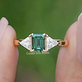 Front view of Emerald And Triangle Moissanite Three Stone Ring 