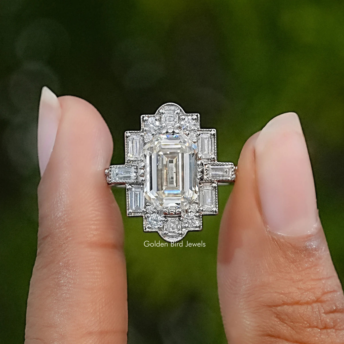 Emerald-cut moissanite accent ring with milgrain detailing and baguette side stones