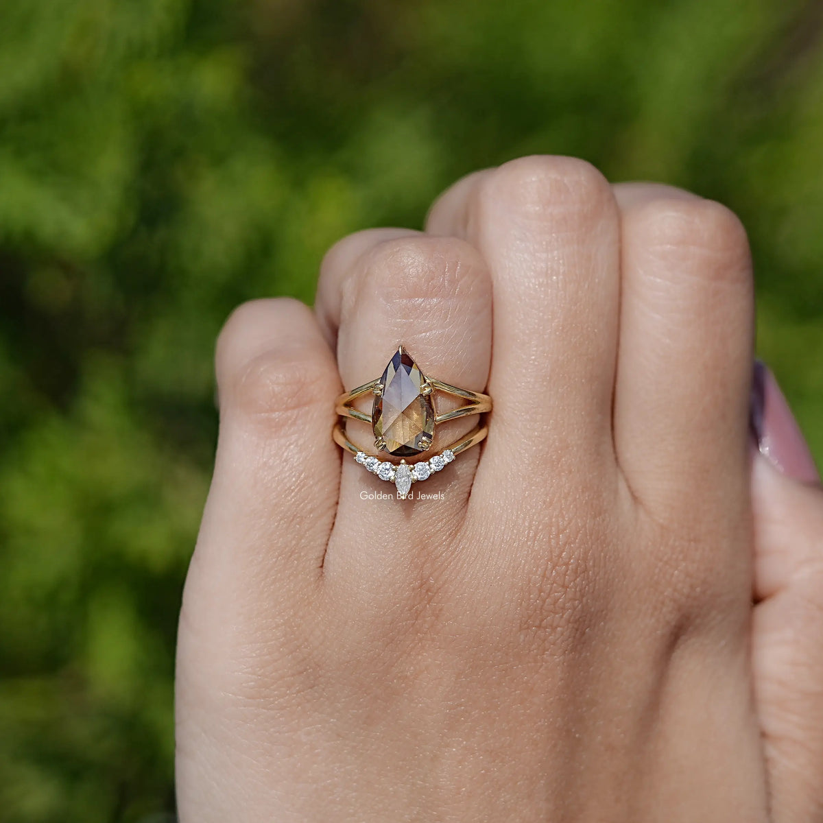 Gold-tone pear-cut solitaire-style ring with double band settings