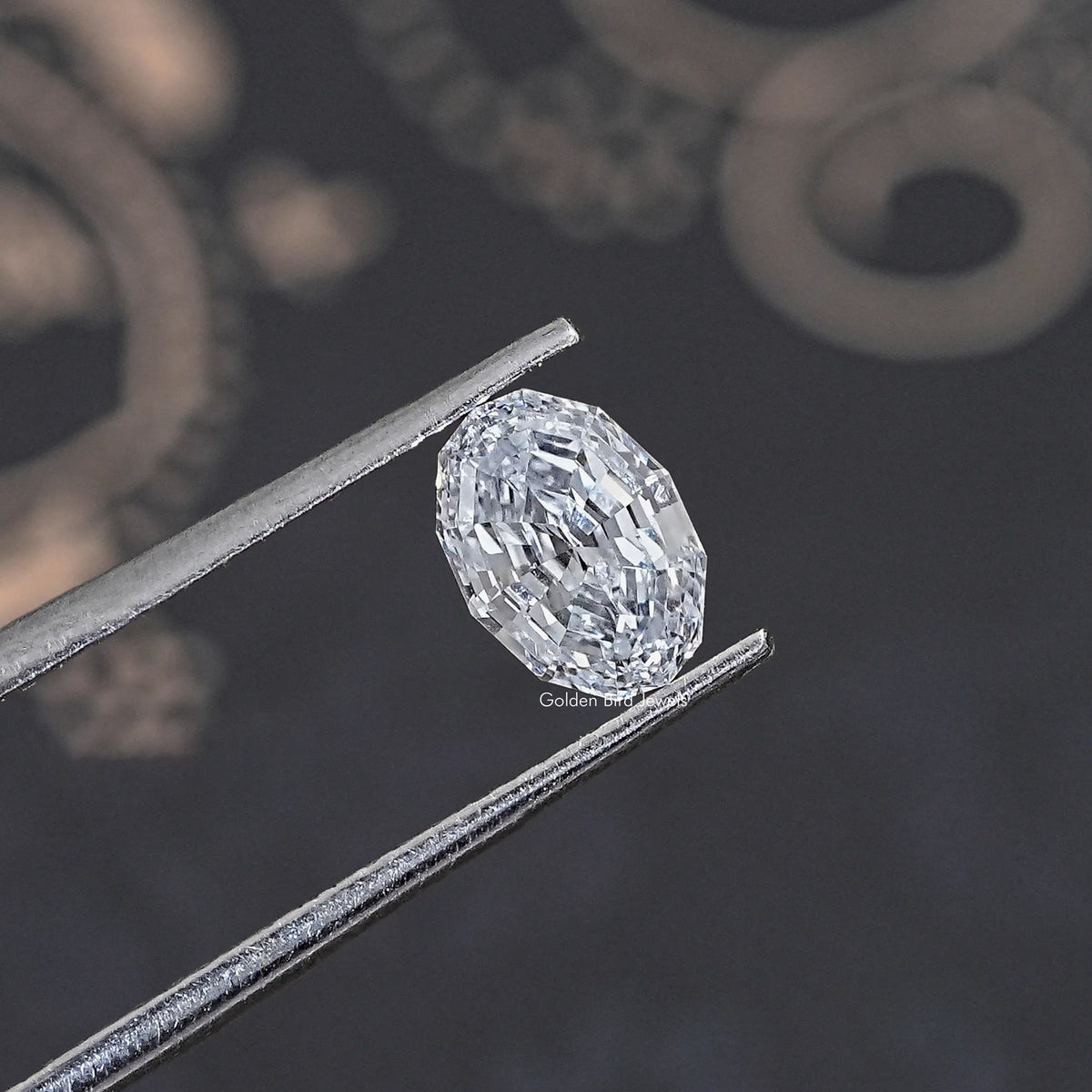 Loose lab-grown oval diamond held in tweezers, step-cut faceting close view