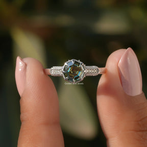 Two fingers holding the Step Cut Octagon Moissanite Accent Stone Ring