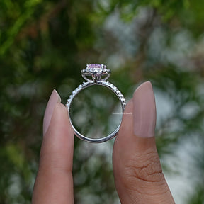 Back View of Pink Oval Cut Gemstone Ring In two fingers
