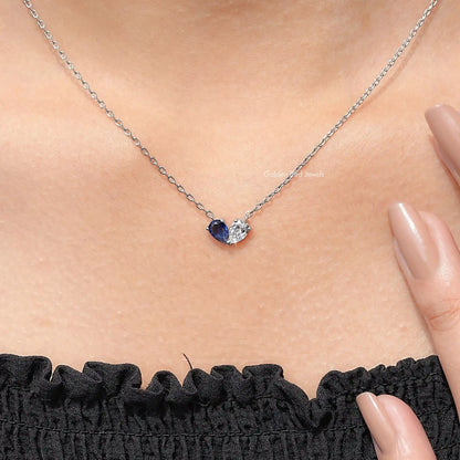 Sterling silver two-stone pendant necklace on chain with blue center stone and clear side