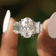 Front view of Crushed Ice Oval And Baguette Cut Moissanite Five Stone Ring in two fingers 