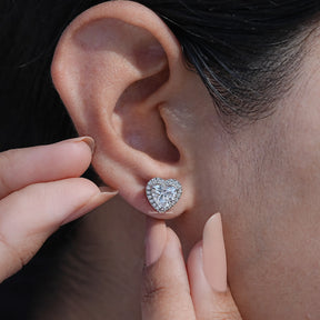 Close-Up View of Heart Shaped Diamond Halo Stud Earrings In White Gold