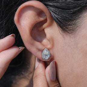 Close-Up View of Pear Cut Moissanite Halo Stud Earrings In Women's Ear's