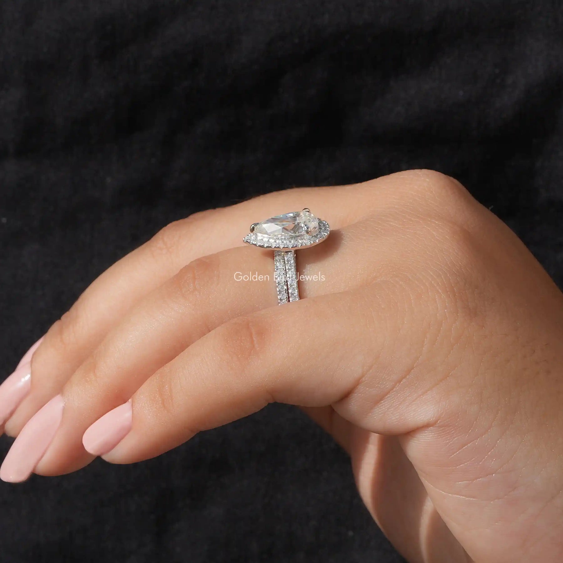 [In finger side view of pear cut moissanite wedding ring set in 14k white gold]-[Golden Bird Jewels]