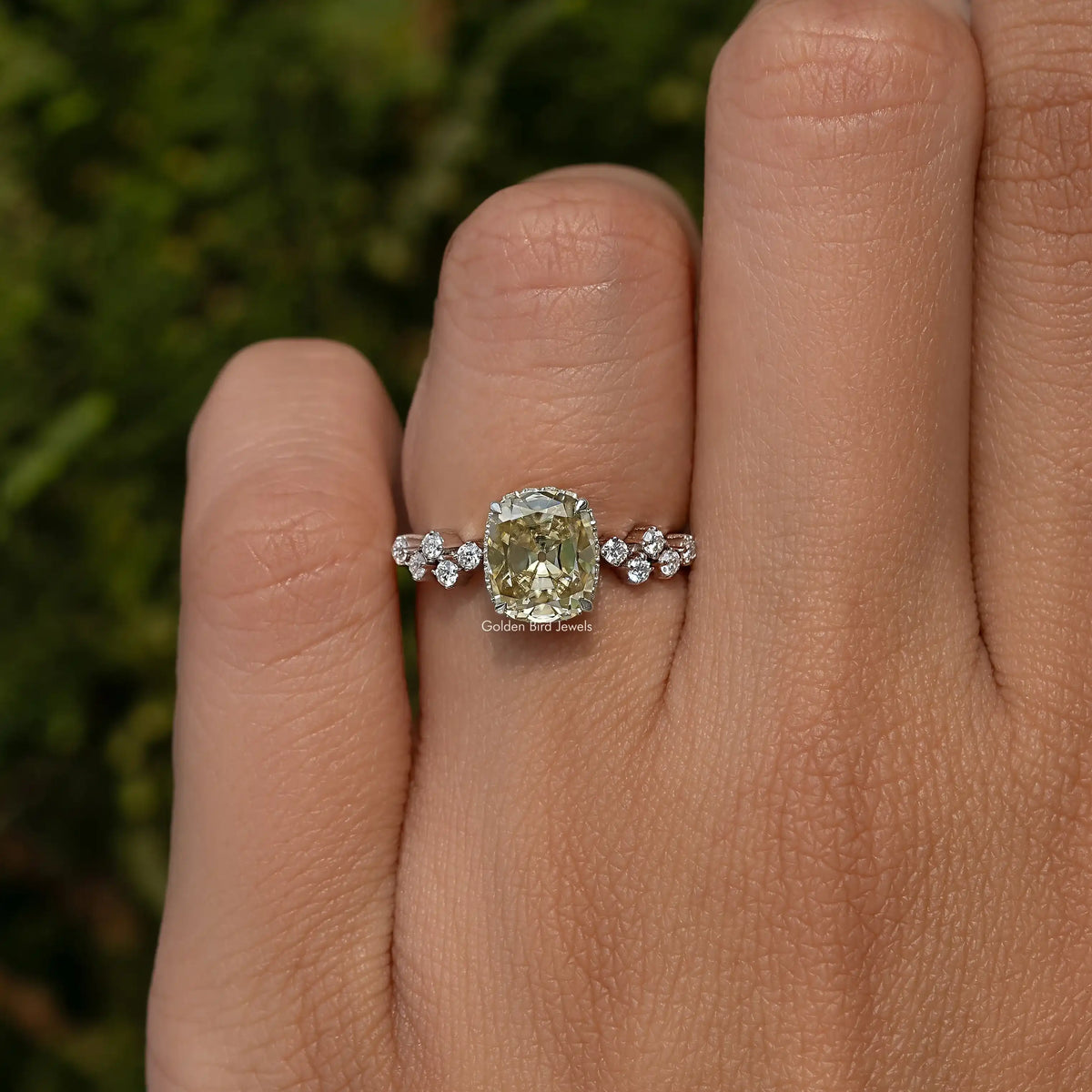 Sterling silver moissanite engagement ring with cushion center stone and round side stones