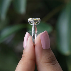 Side View of Cushion Cut Engagement Ring In two fingers