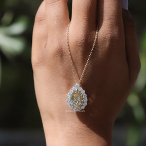 In hand showing a view of moissanite pendant