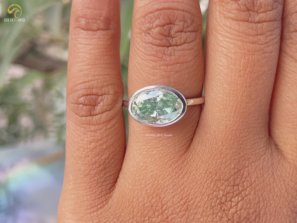 Moissanite East West Bezel Set Oval Cut Solitaire Ring