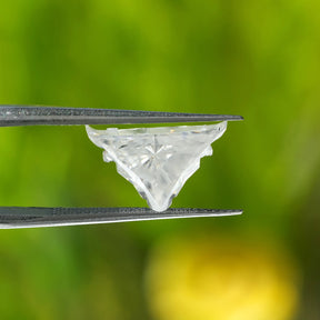 In tweezer front view of antique colorless bull cut moissanite loose stone