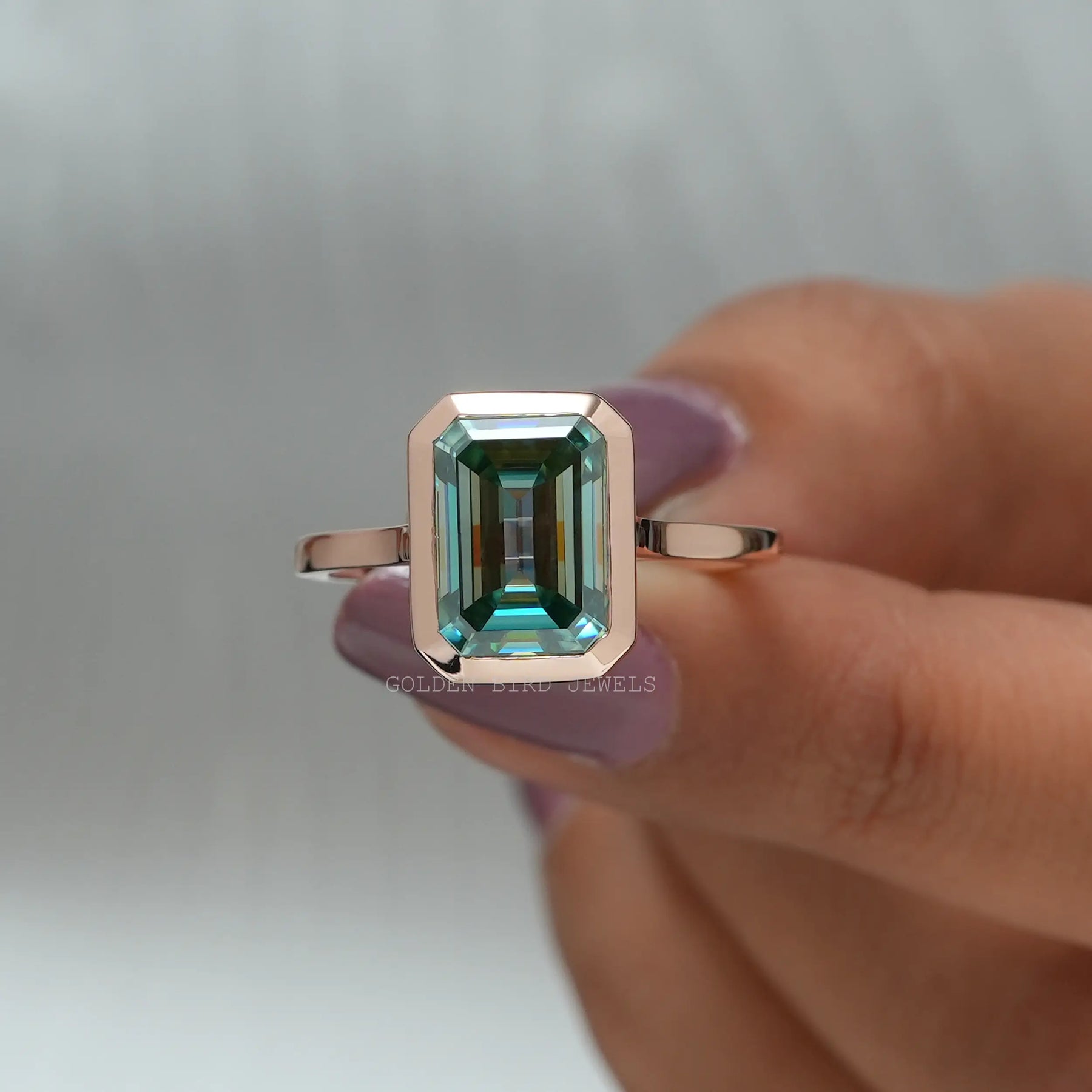 Excellent Front View Of Fancy Blue Green Emerald Cut Moissanite Engagement Ring