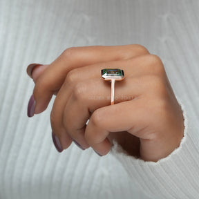 In Finger Side View Of Blue Green Emerald Cut Bezel Moissanite Solitaire Ring For Her