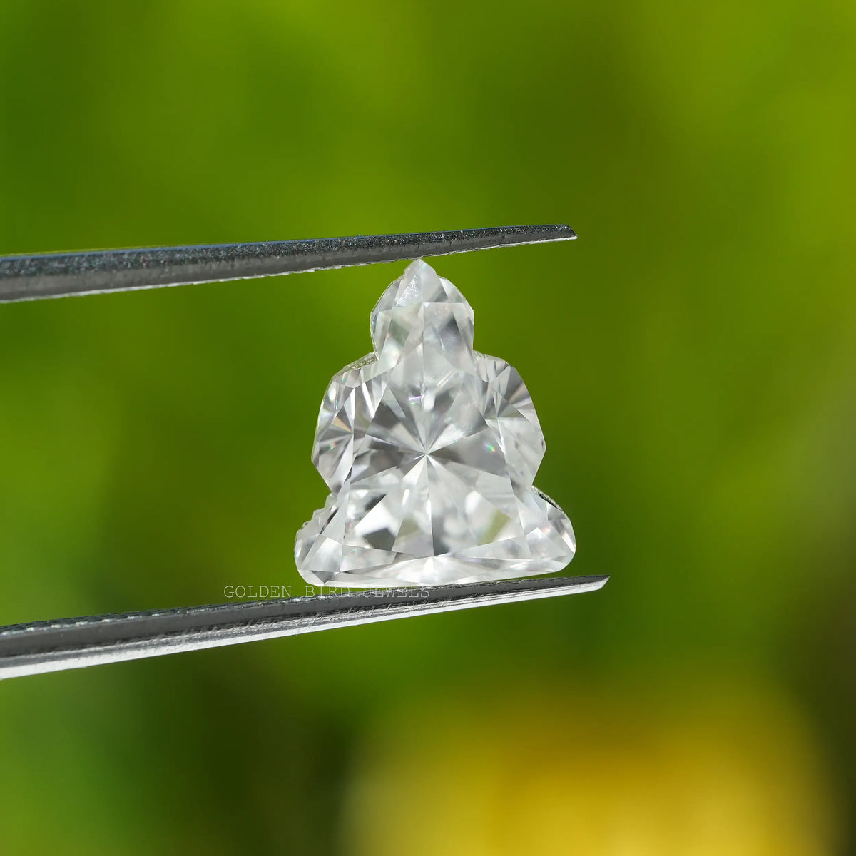 Tweezer holding the Buddha Cut Antique Loose Moissanite Loose