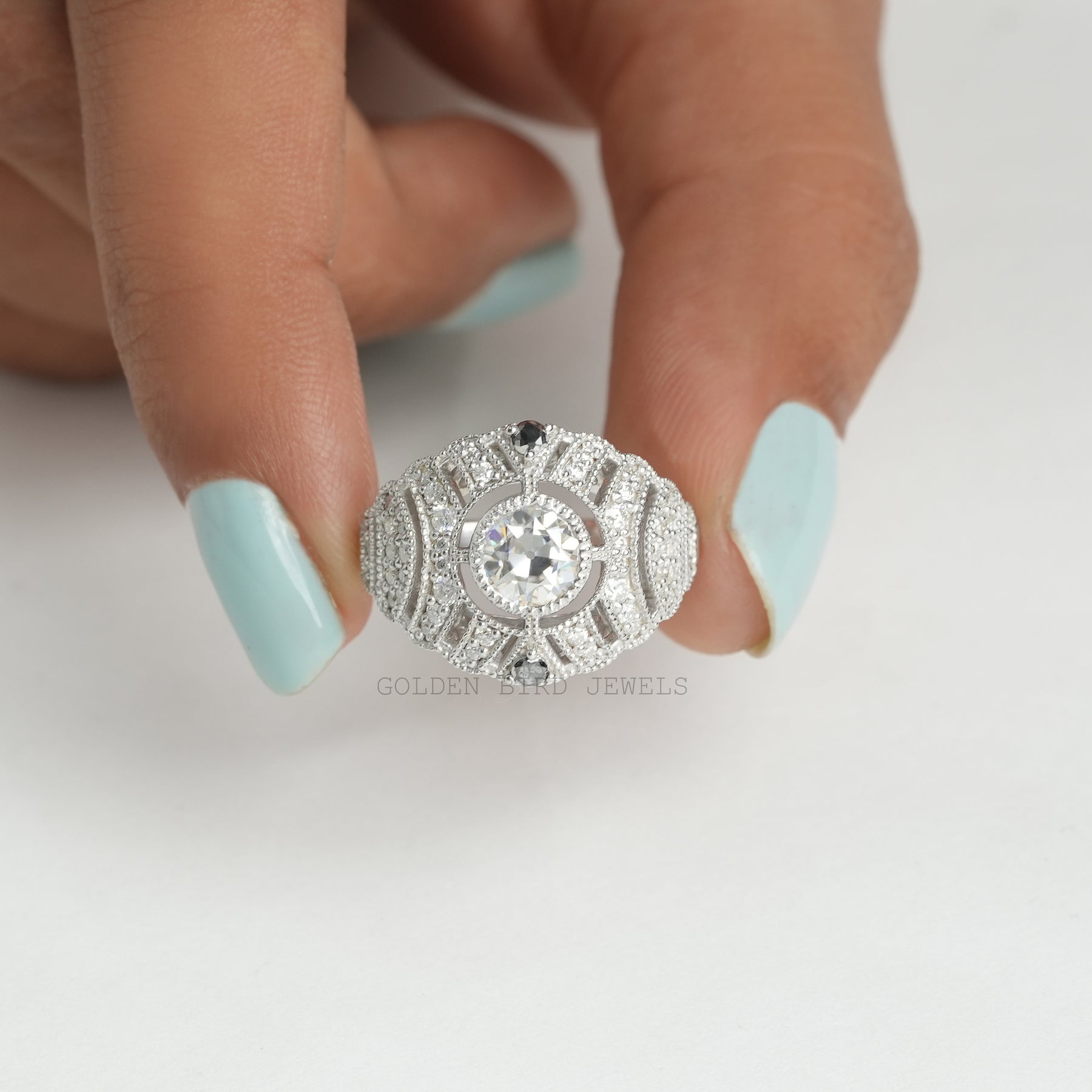 [Front view off round cut moissanite bridal art deco ring set in 18k white gold]