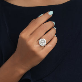 [A woman's hand holding a white stone ring]-[Golden Bird Jewels]