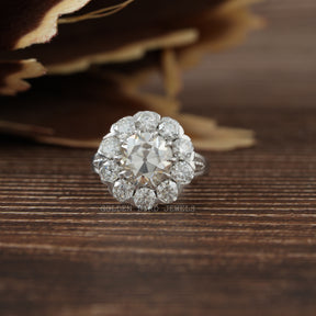 [An antique diamond cluster ring on top of a leaf]-[Golden Bird Jewels]