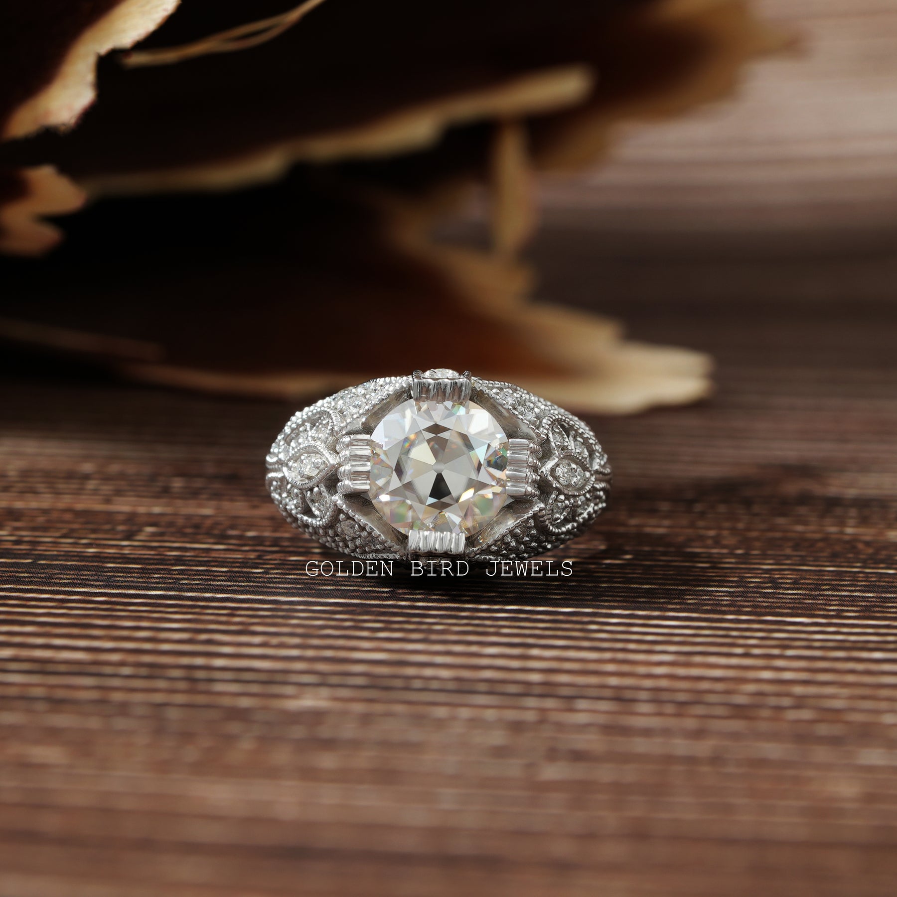 [An antique diamond ring on a wooden table]-[Golden Bird Jewels]