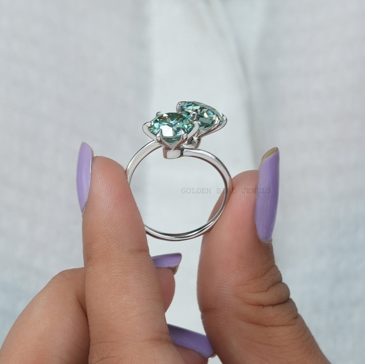 side view of a solitaire blue round cut moissanite  ring  for women 