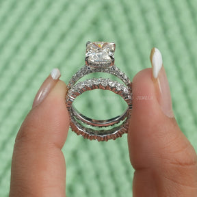 Two fingers holding the Cushion Cut Moissanite Hidden Halo Ring