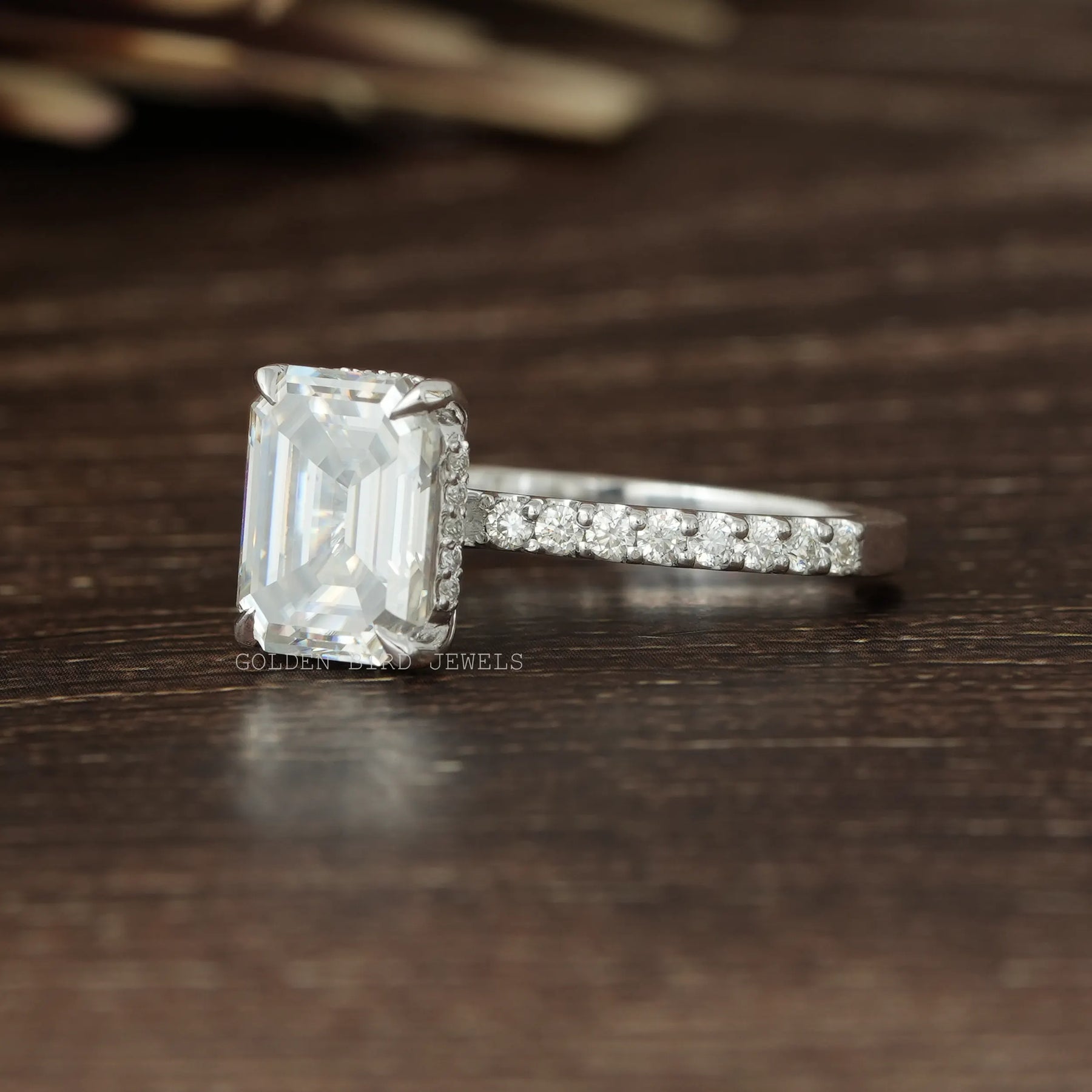 Left Side View OF Emerald Cut Colorless Moissanite With Round Cut Moissanite Hidden Halo Solitaire Engagement Ring