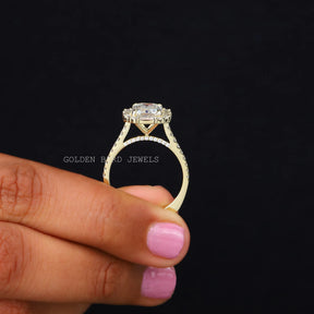 Back View of Emerald And Baguette Moissanite Halo Engagement Ring In two fingers