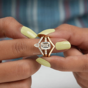 In finger front view of Emerald Cut Moissanite Bridal Ring Set In Yellow Gold