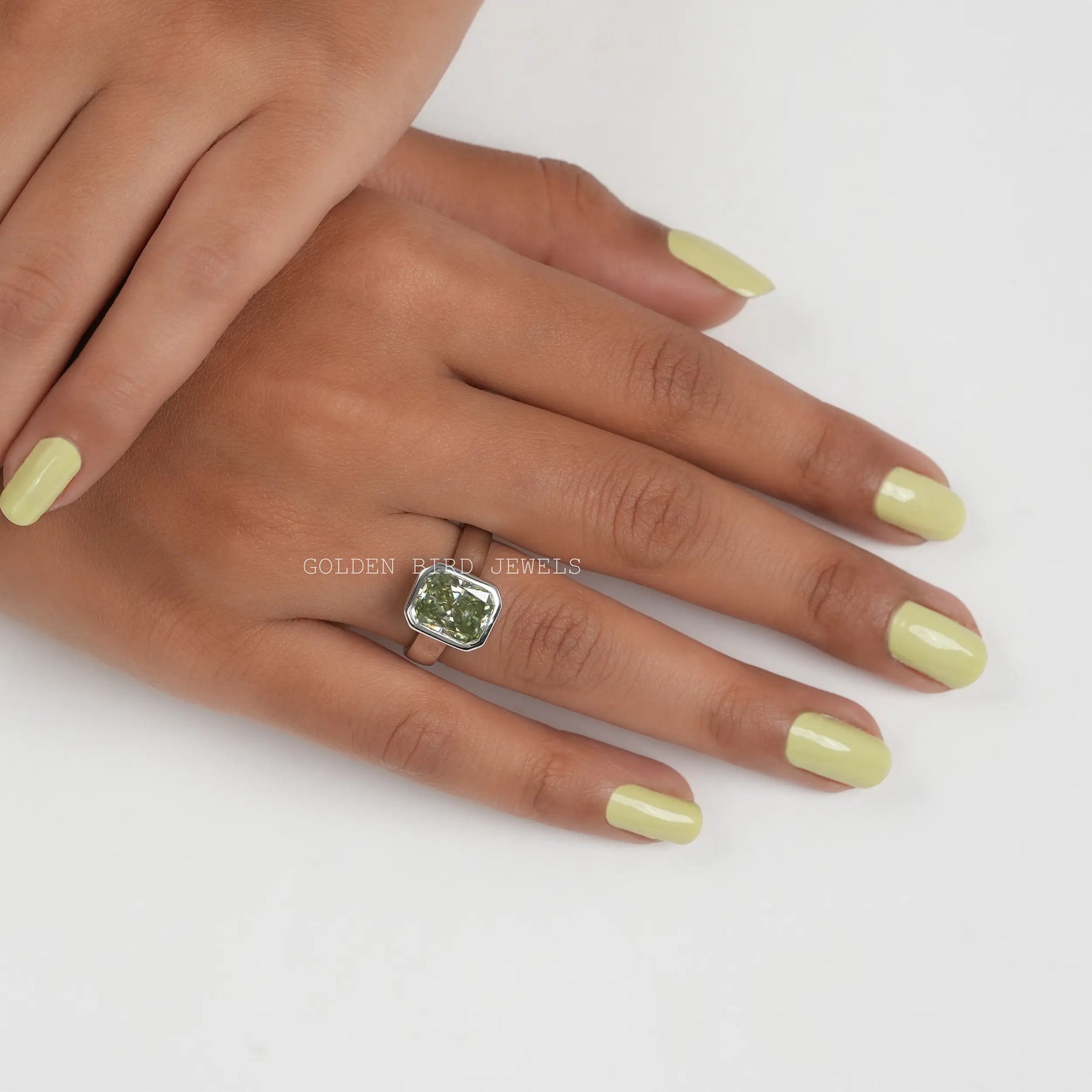 In Finger Front View Of Mint Green Radiant Cut Bezel Set Moissanite Ring