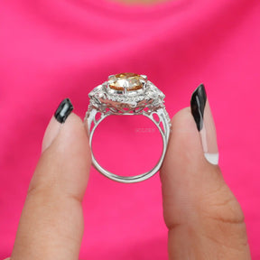 [In two finger front view of old european round cut moissanite cluster halo ring made of side stones]