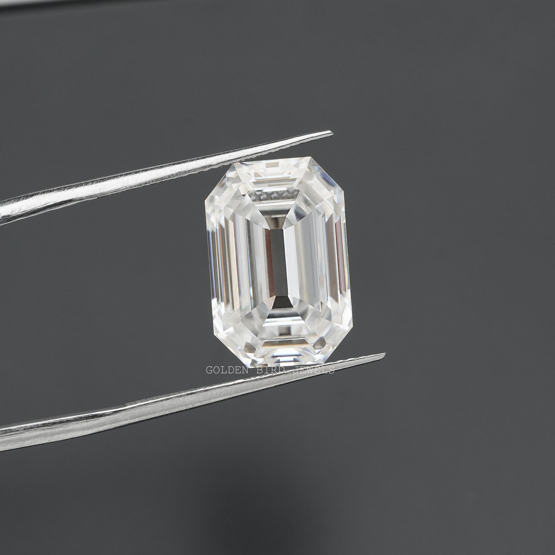 in tweezer front look of old mine emerald cut moissanite loose stone