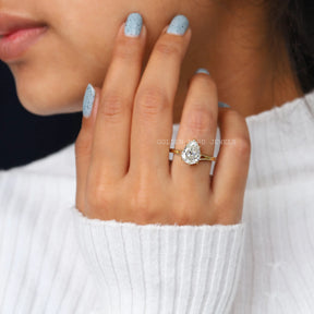 In Finger View Of 2.50 Carat Old Mine Cut PEar Shape Moissanite Engagement Ring