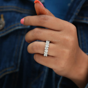 in finger view of pear cut moissanite full eternity wedding band