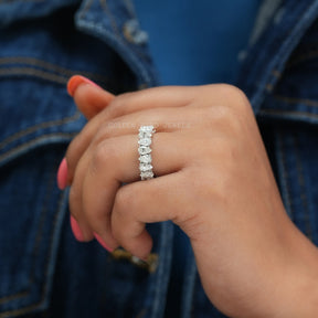 hand view of pear cut moissanite eternity wedding band