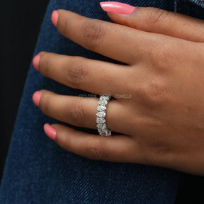 hand view of brilliant cut pear shaped eternity wedding ring made with white gold