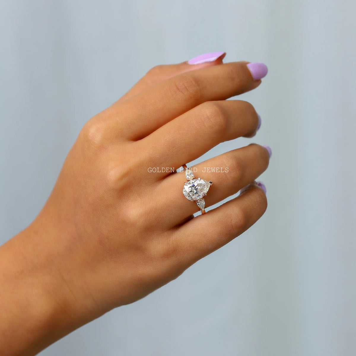 In Finger view of pear-cut moissanite anniversary ring 