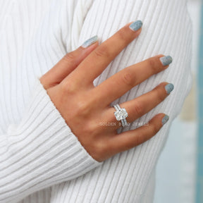 In Finger Front View Of Colorless Radiant Cut Moissanite Engagement Ring With Round Cut Moissanite Eternity Matching Band